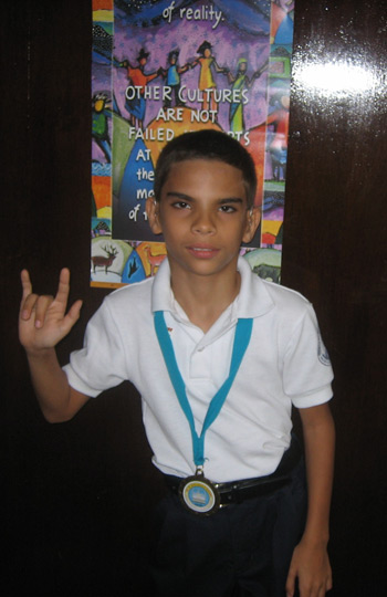 A young man showing the sign language symbol for I love you