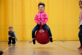 girl bouncing on ball